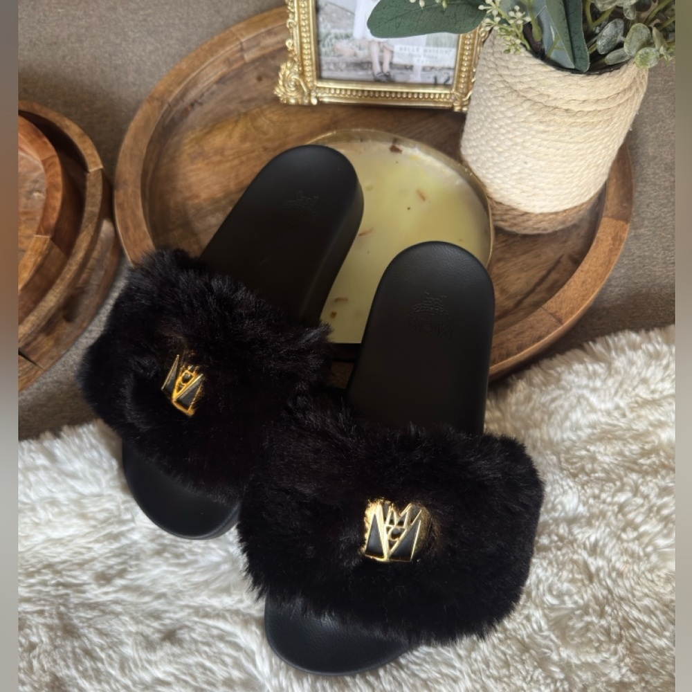 MCM Black Fur Slippers with Gold Accent.